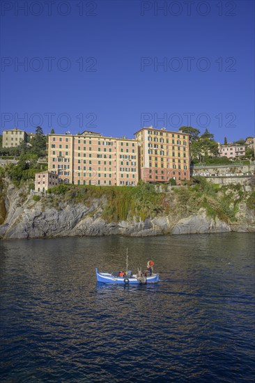 Historic skyscrapers and fishing boat leaving the port of