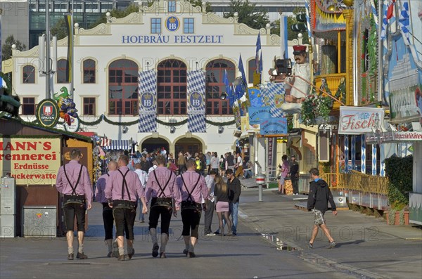 Group of men in lederhosen on road to Hofbraeu tent