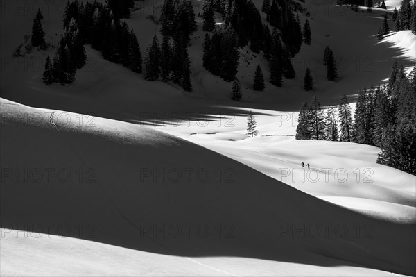 Two ski tourers in wintry mountain landscape