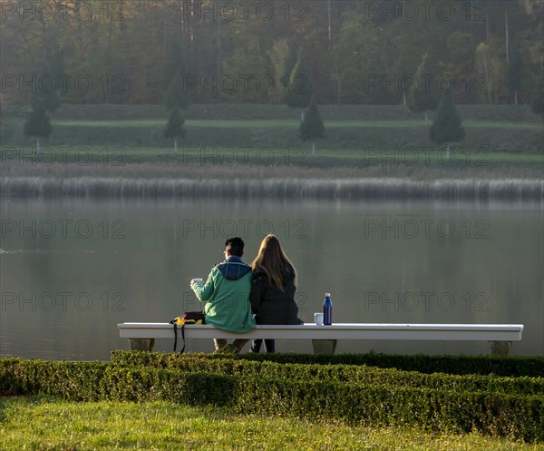 Two hikers taking a rest by the lake