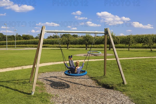 Woman on swing in the Garden of Eden