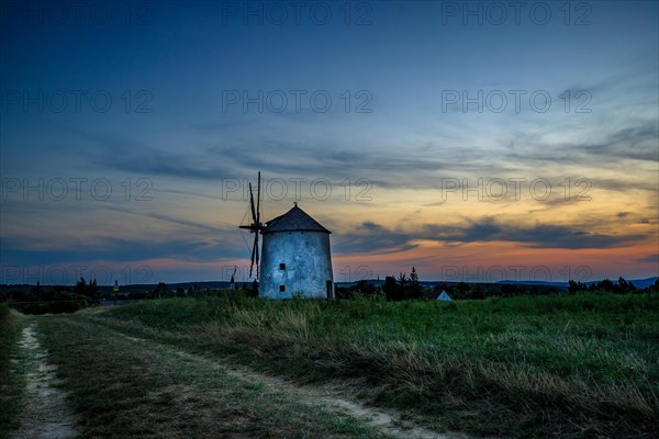 The Old Windmill of Tes in the sunset with guests