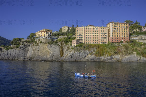 Historic skyscrapers and fishing boat leaving the port of