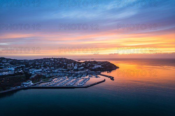 View over Torquay and Torquay Marina from a drone in sunrise time