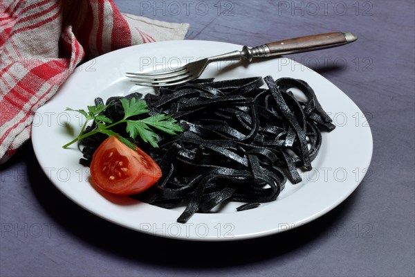 Black pasta with squid ink on plate