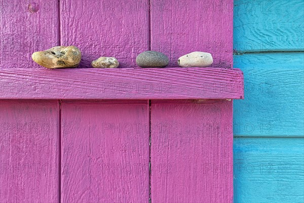 Four discarded stones on a beam