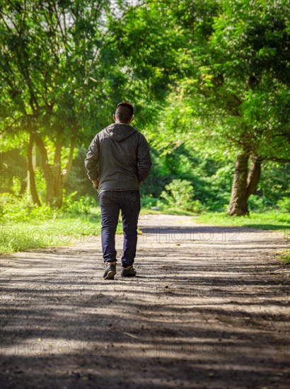 Man walking down a desolate road