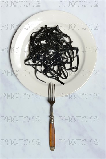 Black pasta with squid ink on plate