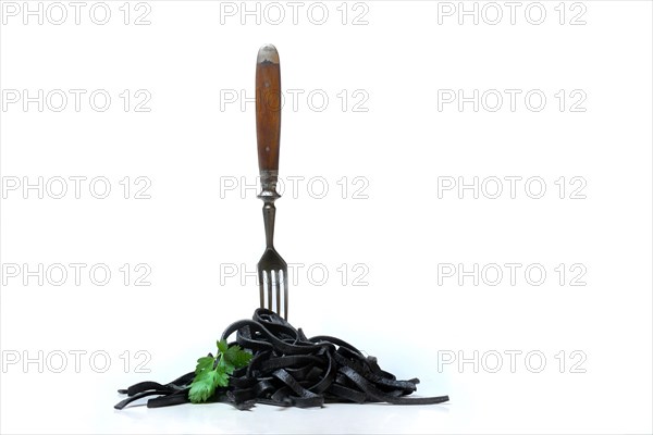 Black pasta with squid ink with fork