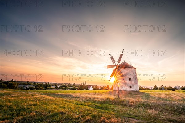 The Old Windmill of Tes in the sunset with guests