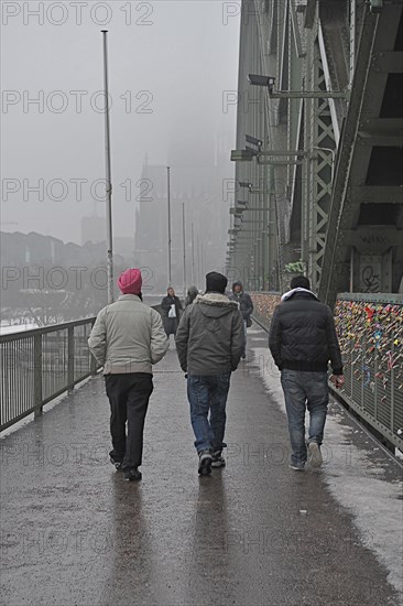 Indian Sikhs on Hohenzollern Bridge with fence of love locks