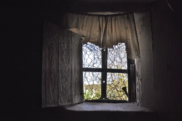 Window with plastic curtain in abandoned house