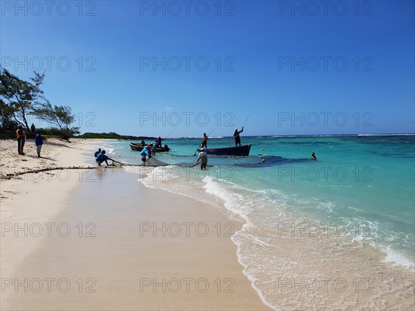 Fishermen on the sandy beach