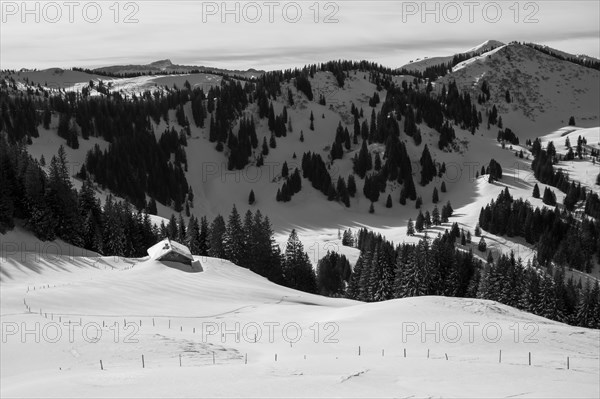 Snow-covered mountain hut in wintry mountain landscape