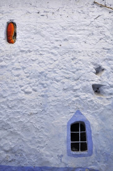 White wall with blue framed window