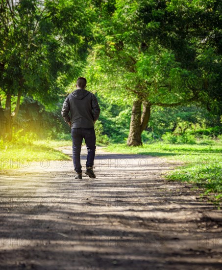 Man walking down a desolate road