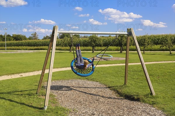 Woman on swing in the Garden of Eden