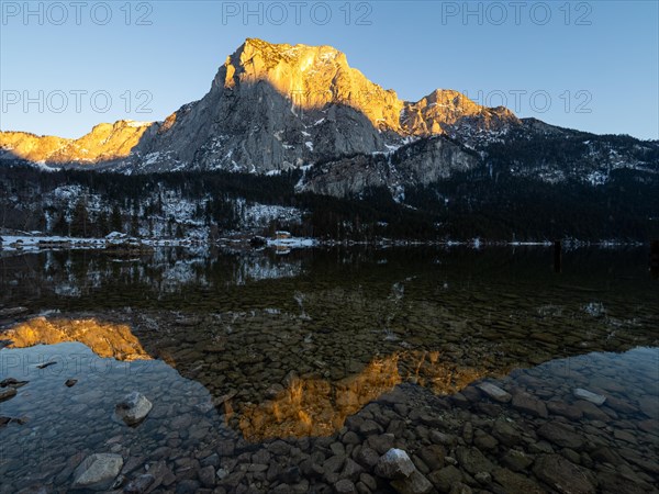 Evening sun illuminates the Trisselwand at Lake Altaussee