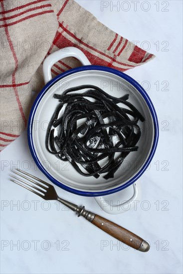 Black pasta with squid ink in bowl