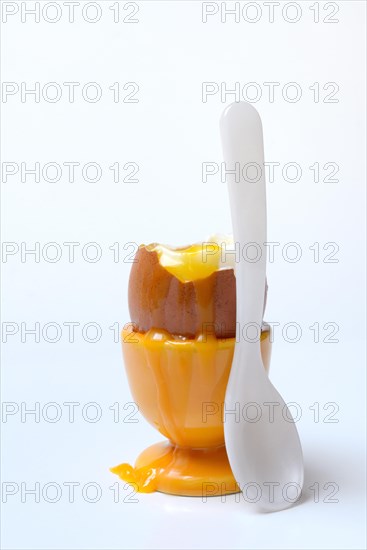 Soft boiled breakfast egg in egg cup with spoon