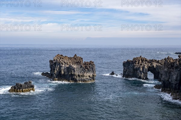 Rocky lava coast with rock gate