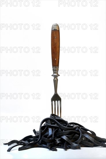 Black pasta with squid ink with fork