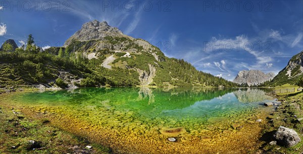 Mountain panorama at the turquoise Seebensee with the mountain peaks of the Sonnenspitze and the Wetterstein massif with reflection