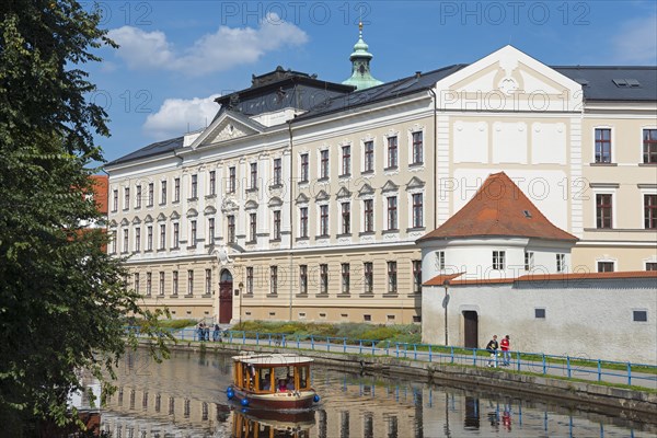 Grammar school and boat on the river Malse