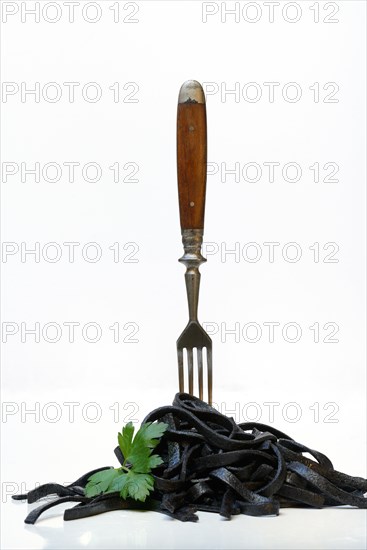 Black pasta with squid ink with fork