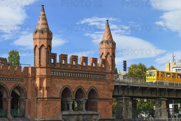 Yellow S-Bahn on Oberbaum bridge over the Spree river