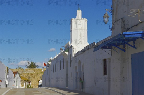 Empty street with tower and city wall