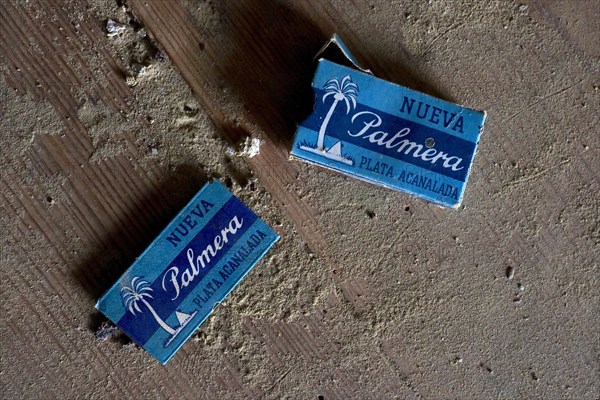 Old packets of razor blades on dusty wooden table