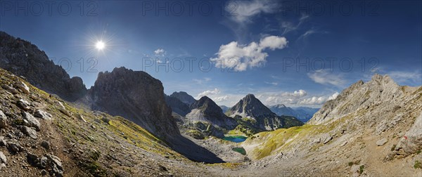 Mountain panorama above the Drachensee and the Coburger Huette with the mountain peaks of the Sonnenspitze