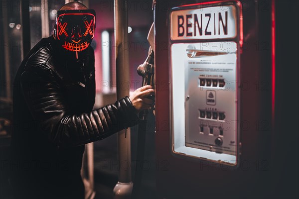 Man with purge mask at petrol pump