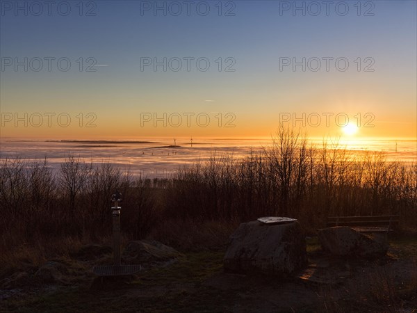 Sunset over cloud cover on mountain top