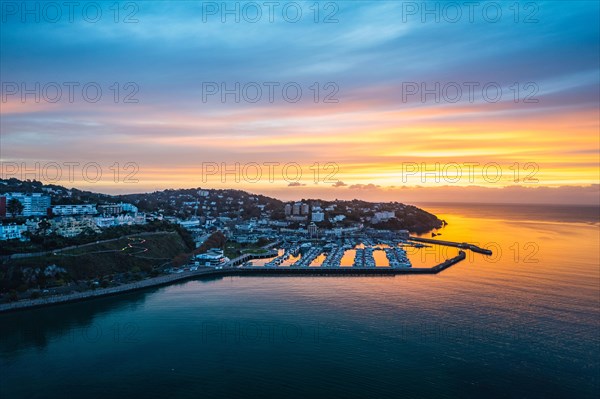 View over Torquay and Torquay Marina from a drone in sunrise time