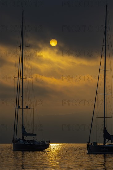 Sailing yachts anchored at sunrise in Portofino Bay