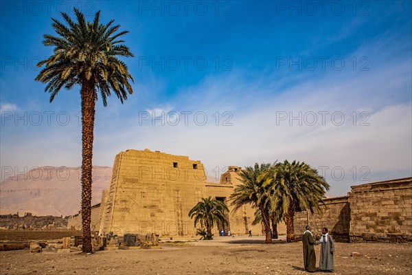 1st pylon in the funerary temple decorated with oversized relief depictions showing the pharaoh in typical displays of power slaying enemies in front of a deity