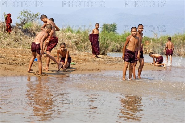 Bathing monks on the banks of the Nam Pilu River