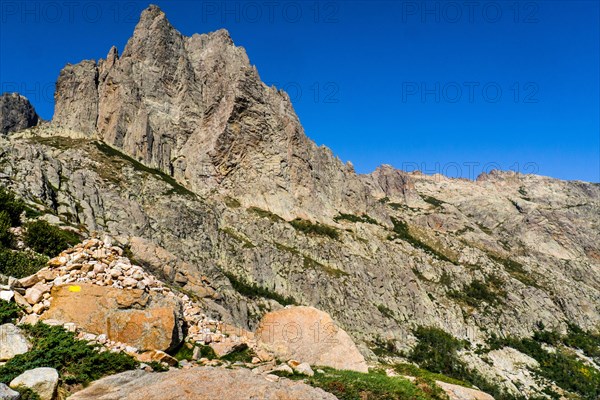 Hiking to the mountain lake Lac de Melo