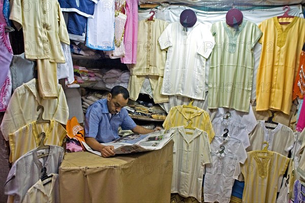 Vendor reading a daily newspaper