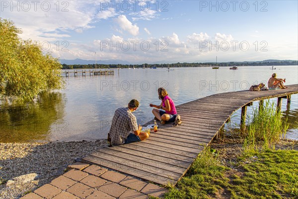 Man and woman sitting on the jetty