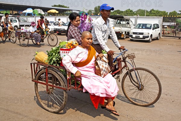 Female monk on cycle rickshaw