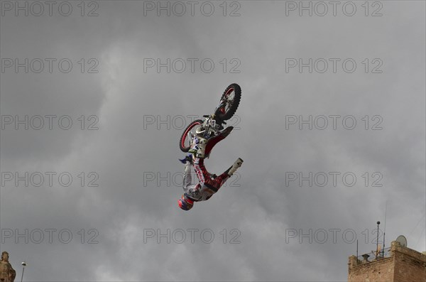 Motorbike performer doing a somersault in the old town of Lorca