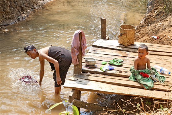 Washing clothes on the banks of the Nam Pilu River