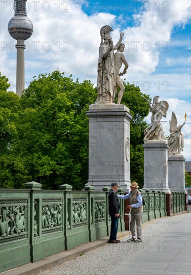 Seniors in dialogue on the Schlossbruecke in Mitte