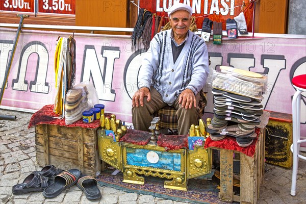 Shoeshine boy at the Hacibayram Mosque