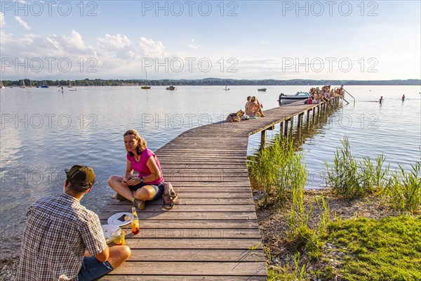 Man and woman sitting on the jetty