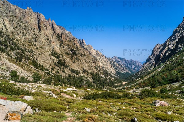 Hiking to the mountain lake Lac de Melo