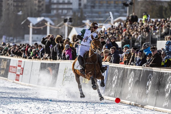 Spectators watch Santiago Marambio of Team Azerbaijan Land of Fire trying to control the ball at the rail